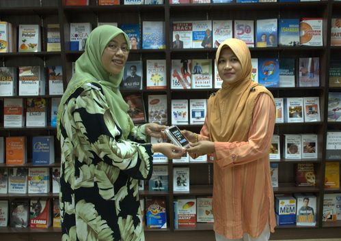 Cik Shazarina (PTS) bertudung hijau menyampaikan hadiah iPod Touch kepada Puan Izuana (bertudung oren - kanan)