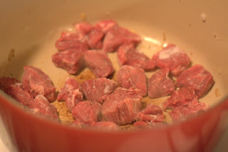 picture of beef being browned in dutch oven