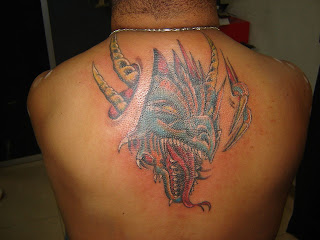 Tribal dragon head tattoo on the back