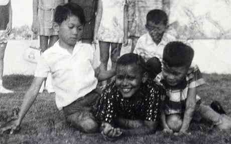Barack Obama, afterwards well well known as Barry Soetoro, center, is graphic at a classmate