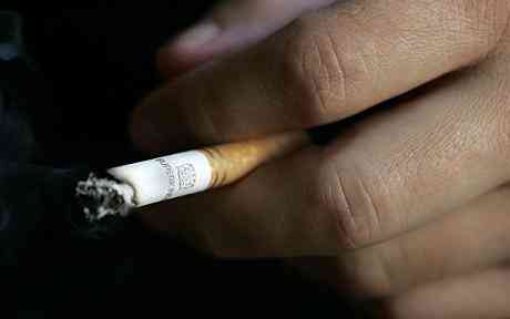 Hand holding Cigarette Cigarette vending machines should be banned, doctors contend 