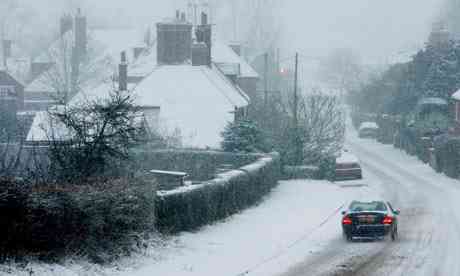 A motorist eases by Great Chart in Kent, as sleet white conditions go on opposite the country