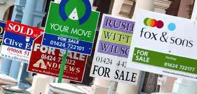 Estate agents signs outward a row of properties