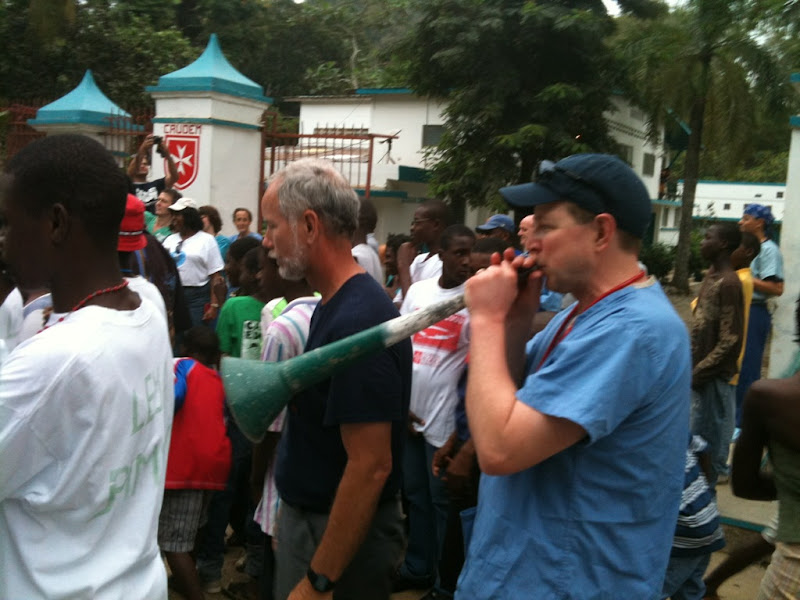 David Dirrim and Brent Dennis join in a celebration outside of Sacred Heart Hospital on Sunday. The town's people gave a parade for all of those working at the hospital.