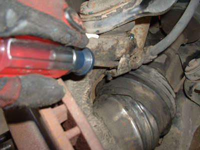 Then remove the brake line bracket from the ball joint stud.  This will allow you to move the brake caliper out of the way later.