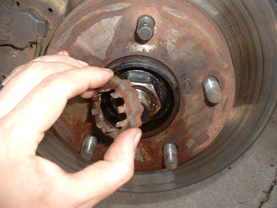 Then pull the cotter pin from the axle nut and remove the retainer.