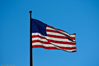 Shining Glory: This image doesn't really convey the true sense of scale - this flag is truly huge. But on this day the sun was shining behind it, and gave the flag a translucent shimmery look that I couldn't pass up! (1/1000 sec @ f/5; 190mm) Copyright 2009, Kerri Shotts