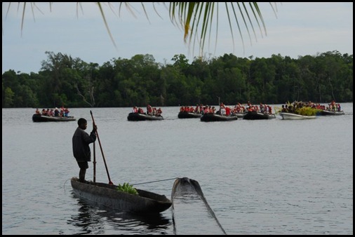 Boat loads of visitors arriving in Watam Village