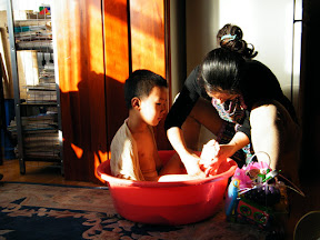 baby bathed by his mom.