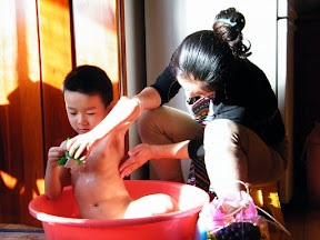 baby with his toys, while his mom bathed him.