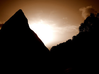 The sun sets behind the mountain.