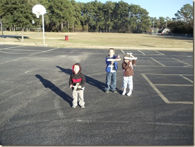 Jeffrey, Travis, Heather with rubber band airplanes
