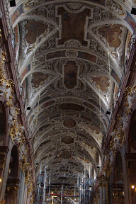 High ceilings.  Baroque-style ornaments.  Scaffolding.