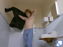 Graham dressing in a gas station bathroom