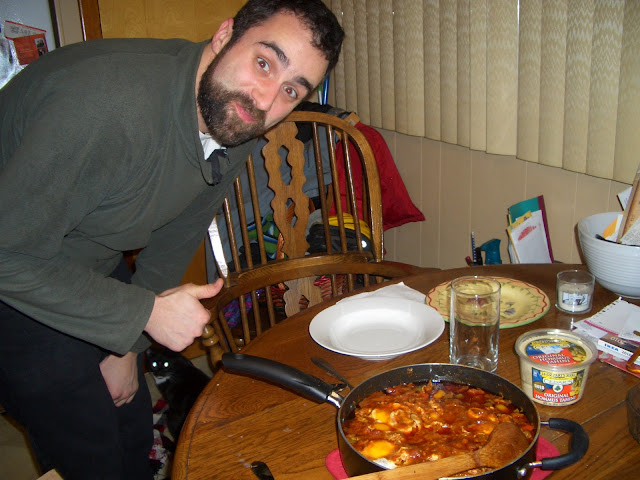 Note the hummus on the table. It's the perfect compliment to the shakshouka. We also had fresh and chunky olive paste with it. Also note our cat Petunia under my thumbs up. She's the perfect compliment to shakshouka making.