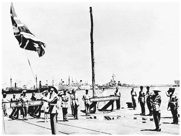 Removing the British Flag in Haifa, June 30, 1948. After World War I, Great Britain was entrusted with the mandate of Palestine. Shortly after the state of Israel was proclaimed in May 1948, a British soldier hauls down the British flag in Haifa Harbor prior to the departure of the last British troops. 