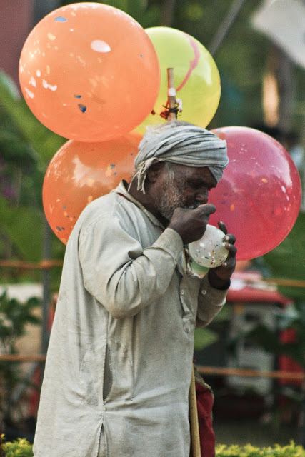 A seller pumping balloons A seller pumping balloons