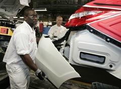 Honda associates install a Crosstour rear bumper at East Liberty from 1-10