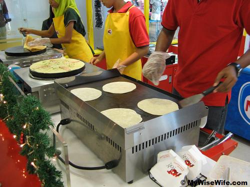 Thawed flat bread is heated on electrical stove