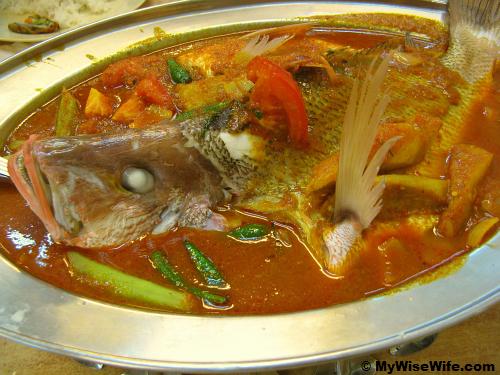 Huge fish in curry and some assorted vegetables Huge fish in curry and some assorted vegetables