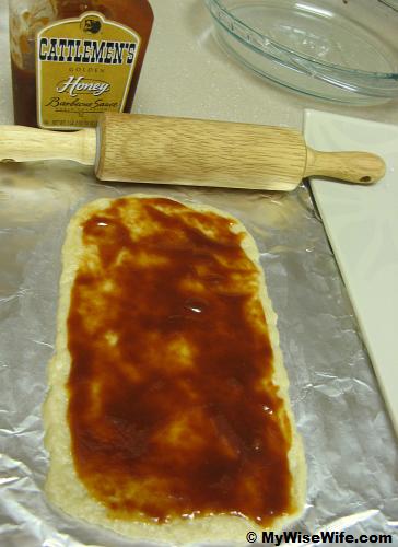Flatten pastry is baste with BBQ sauce