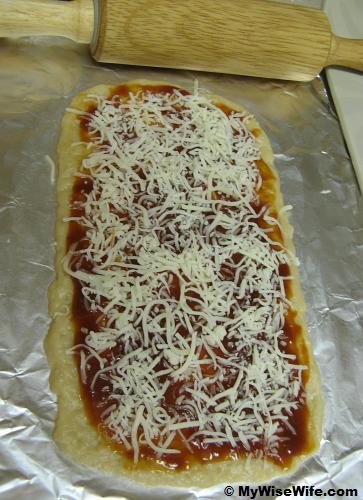 Pastry sheet with BBQ sauce and grated cheese
