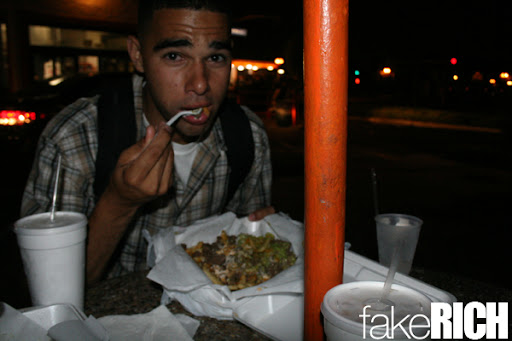 At ease. With some meat in his mouth.