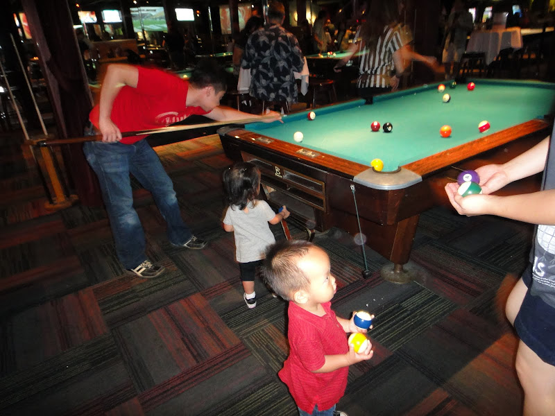 Daddy shooting pool.