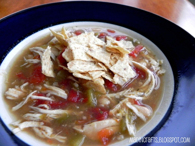 chicken tortilla soup in a bowl topped with tortilla chips