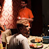 Lindsay Mann works out the dinner table scene. The canned ham just sits there.