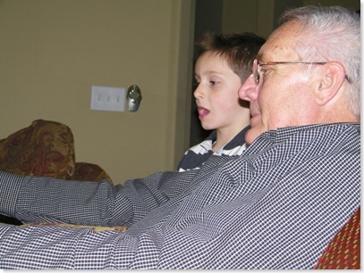 Logan reading a book to Poppa Don
