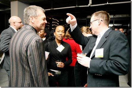 Michael Shacklette, President of The Michael Group, left, actor Sonja Sohn, head of Rewired for Change, middle, and Michael Blake, Mark Thomas Architects, right, talk during the ULI christmas party sponsored by the Michael Group at the Legg Mason tower in Downtown Baltimore. Photo by Arianne Teeple