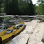 The Souris 17 canoe poses next to a rapid along the Kawishiwi River