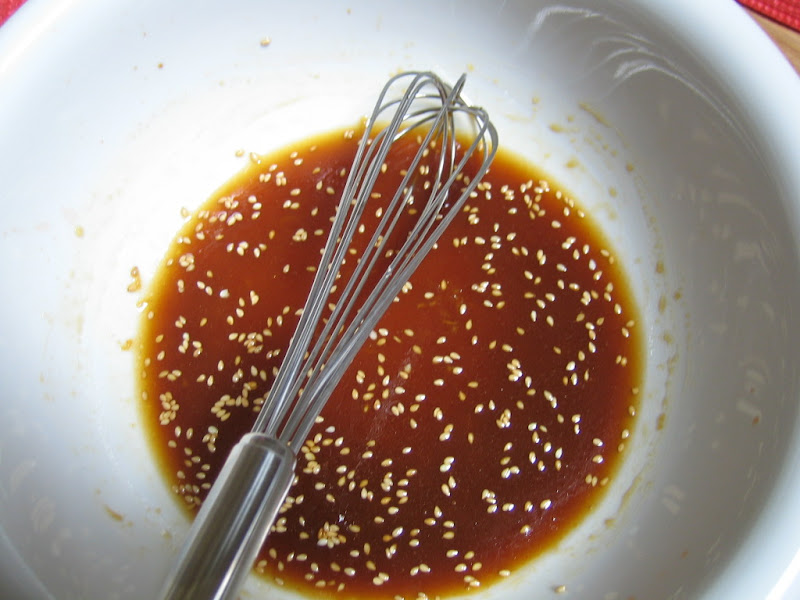 Whisking together the sesame dressing for the noodles