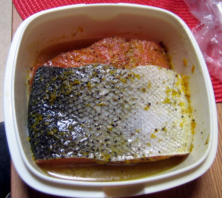 The two salmon fillets on top of each other in a fish sandwich. Make sure to flip over the sandwich every 12 hours so the rub penetrates the fish evenly