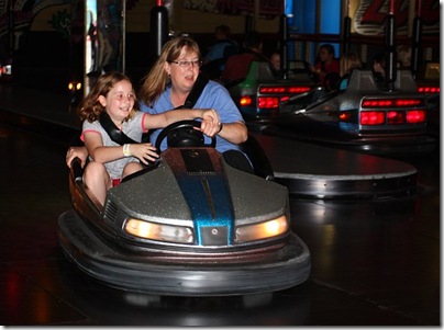 Elena and Heather riding a bumper car at Luna Park