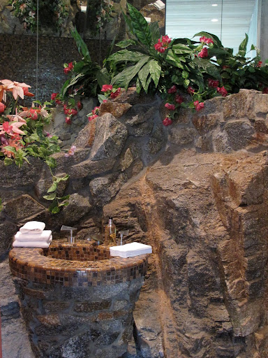 A bathroom in the guest house, where the landscape's boulders come inside