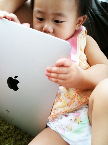 baby playing Apple iPad baby playing Apple iPad