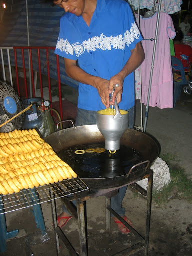 a man pouring food into a large pan