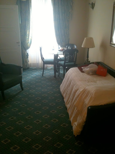 a room with a bed and chairs and a table