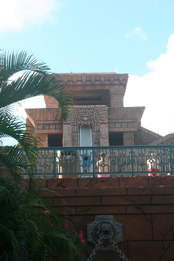 a building with a balcony and palm trees