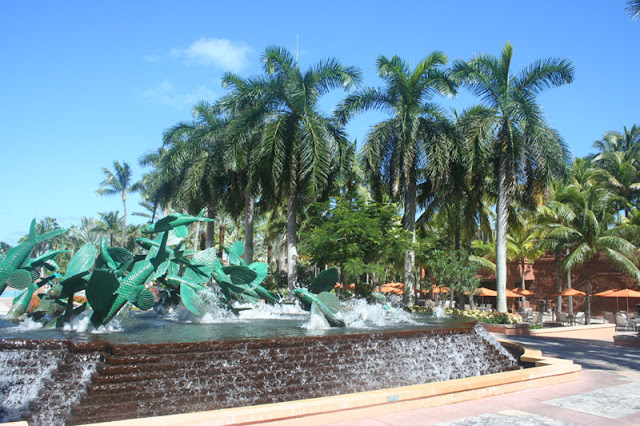 a fountain with palm trees