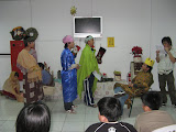 The wise men (Benjamin, Evan, and Dick) visit King Herod (Joseph) as Jones narrates