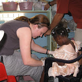 My first patient!  Bandaging up little Camilla, who wore her party dress to school for the holiday.