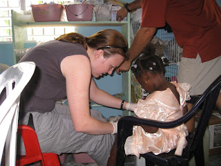 My first patient!  Bandaging up little Camilla, who wore her party dress to school for the holiday.