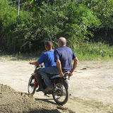 Mike makes a run to hardware store on the back of Chepe's bike.