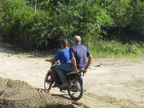 Mike makes a run to hardware store on the back of Chepe's bike.
