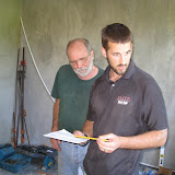 Charlie and Mike hard at work, looking at the plans for the cabinets.