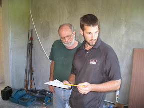 Charlie and Mike hard at work, looking at the plans for the cabinets.