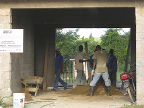 Mixing plaster on the floor by hand.